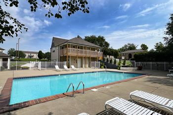 A swimming pool in front of a house